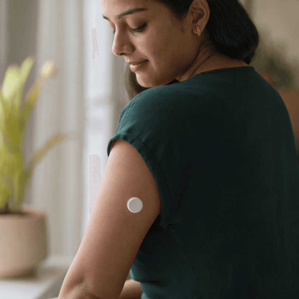 A small round sensor worn on the back of an upper arm