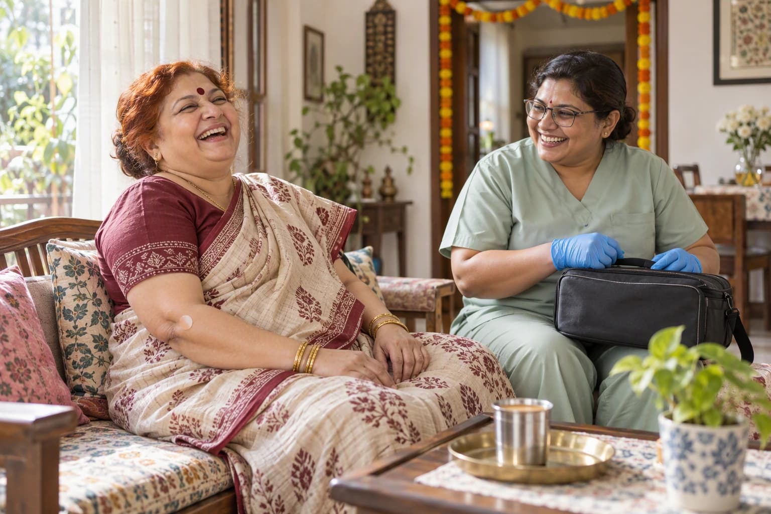 A woman in her fifties with henna-red hair laughing on her divan with a home-collection technician packing her kit