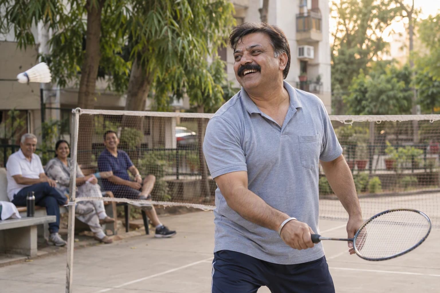 A man laughs mid-rally on a neighbourhood badminton court
